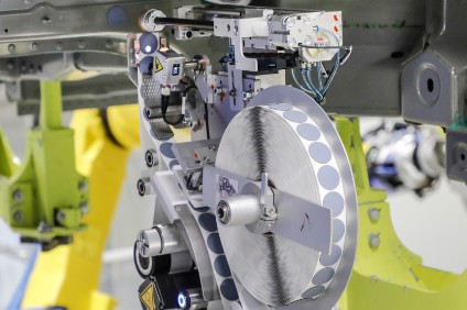 Reel-fed robot applies patches, replacing 3,600 plugs per shift inserted by hand